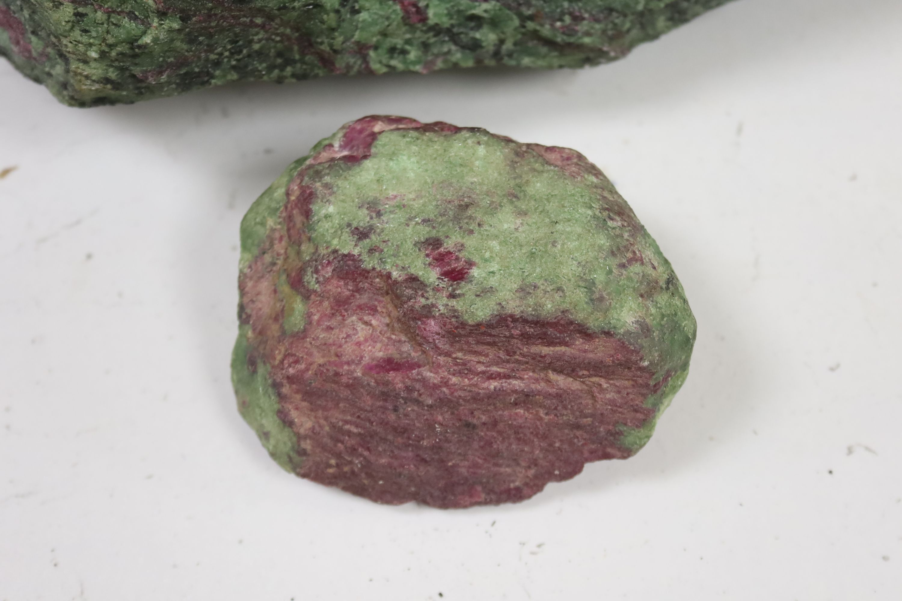 Three fragments of Anyolite (or ruby in zoisite) originating from a ruby mine in Kenya, largest 32 x 22cm